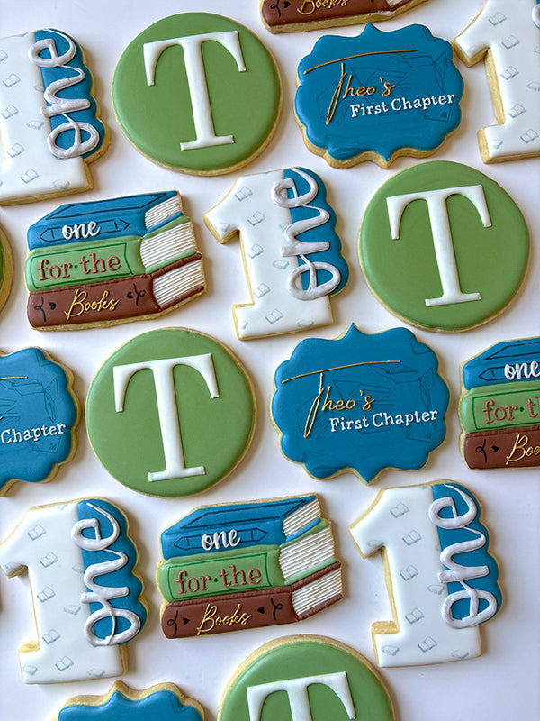 Birthday cookies shaped like books celebrating the first birthday