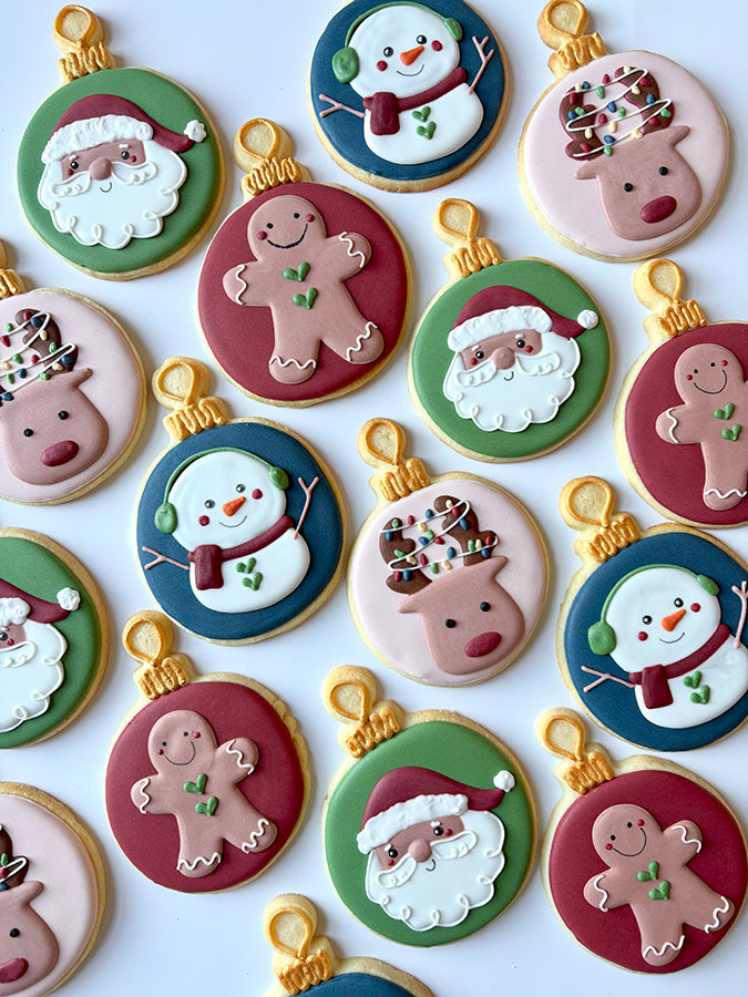 Hand-decorated Christmas cookies with Santa, gingerbread men, and snowmen inside ornaments