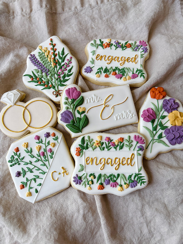 A set of highly detailed floral cookies to celebrate an engagement of a couple
