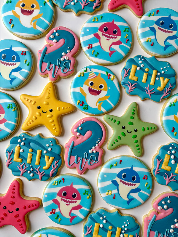 Variety of cookies in the shapes of sharks and starfish for a second birthday