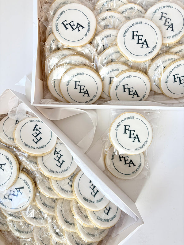 Round cookies with 'FEA' company logo in a box and clear packaging.