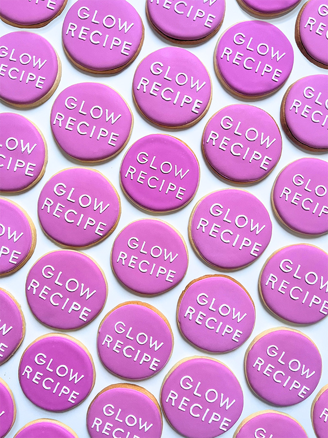 Round lavender cookies with Glow Recipe hand written in icing