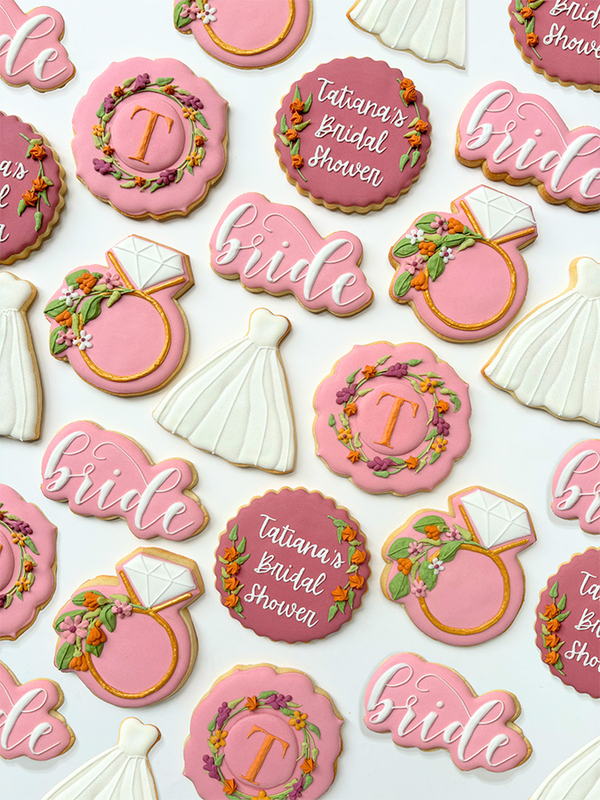 Hand-decorated cookies with bridal dresses and diamond rings